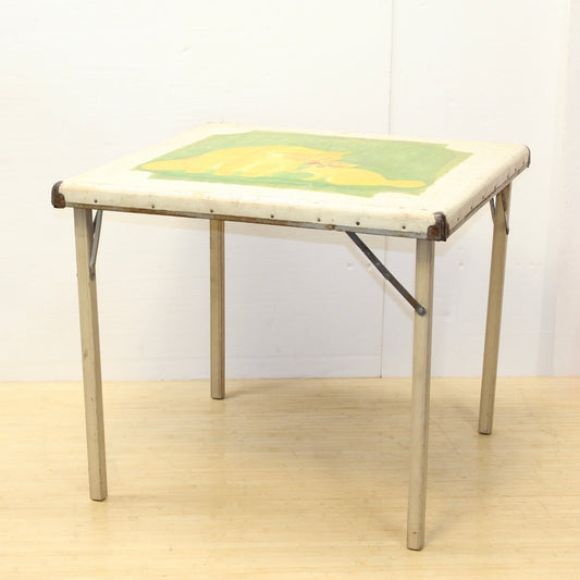 1930 folding wood card table with cat lithograph and a embossed tin fiberboard top. 1930s Shwayder Bros folding Card table.