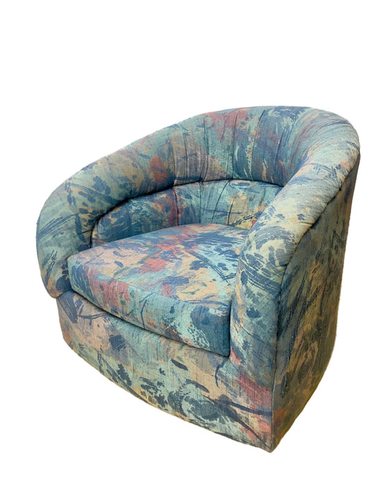 Multicolored swivel chair on a wooden floor with a white wall background