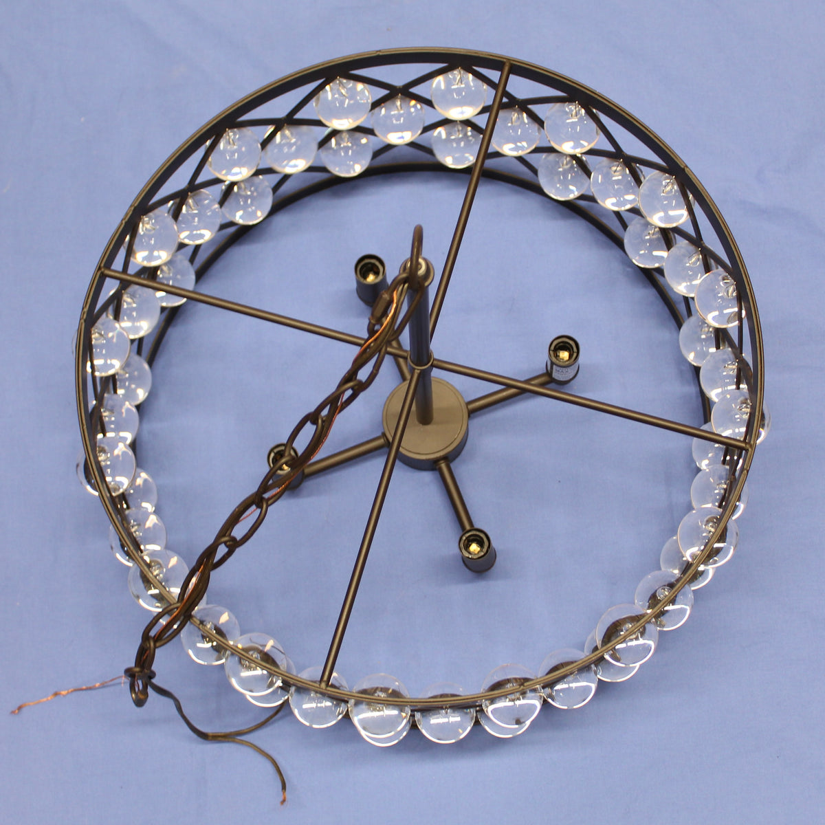 Decorative chandelier with glass balls on a blue background