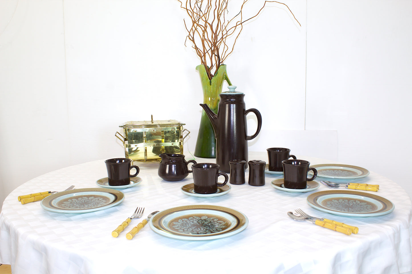 Vintage Stoneware brown and teal in color with  Coffee mugs , saucers, creamer bowl, Dinner plates and a coffee pitcher.