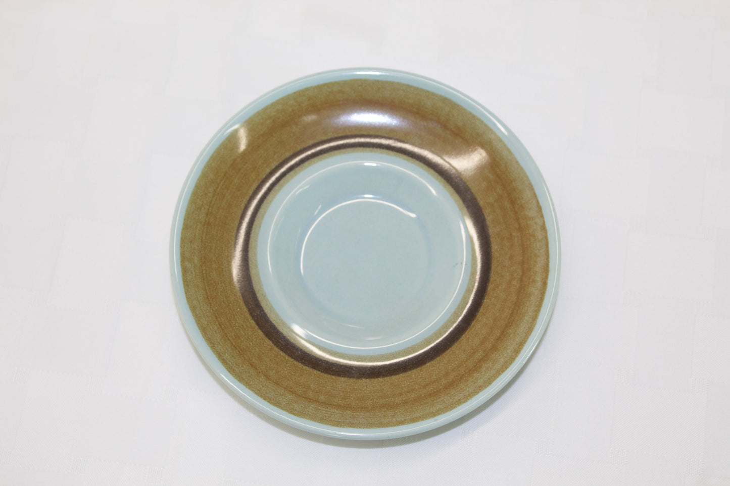 Franciscan Stoneware Saucer in a brown and teal color