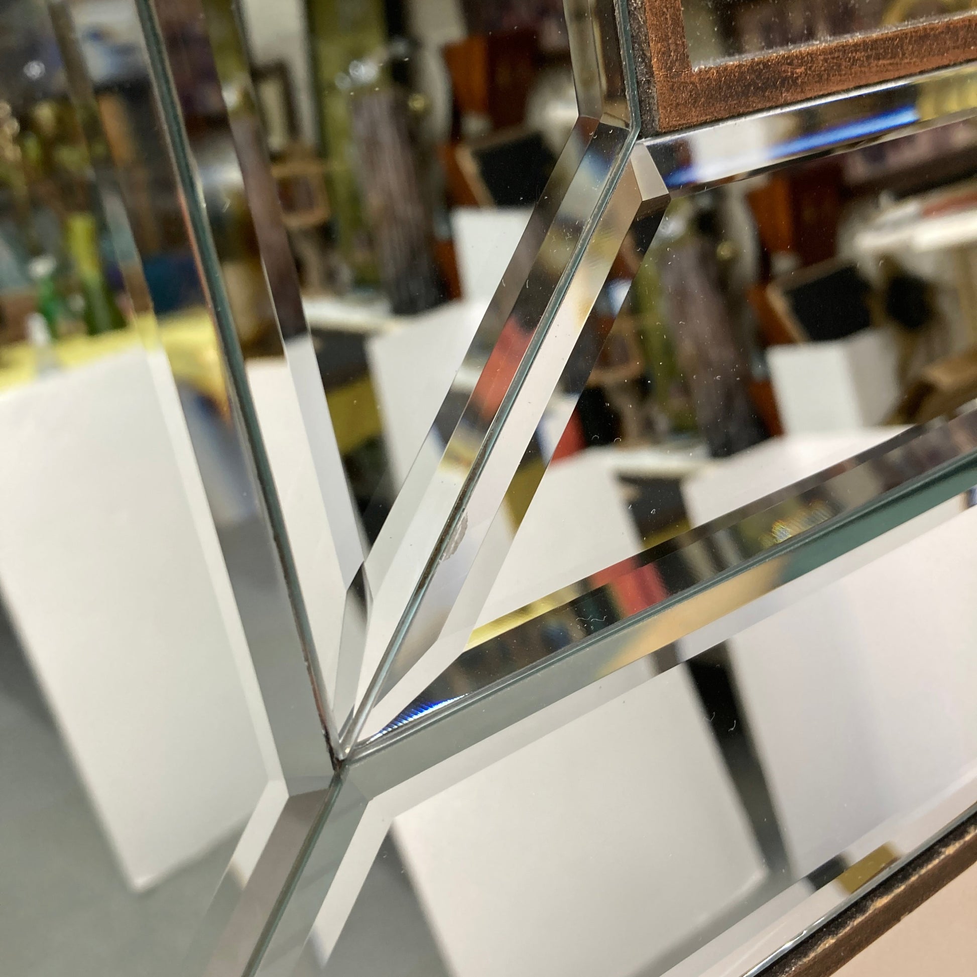 geometric mirror with a copper-toned frame.