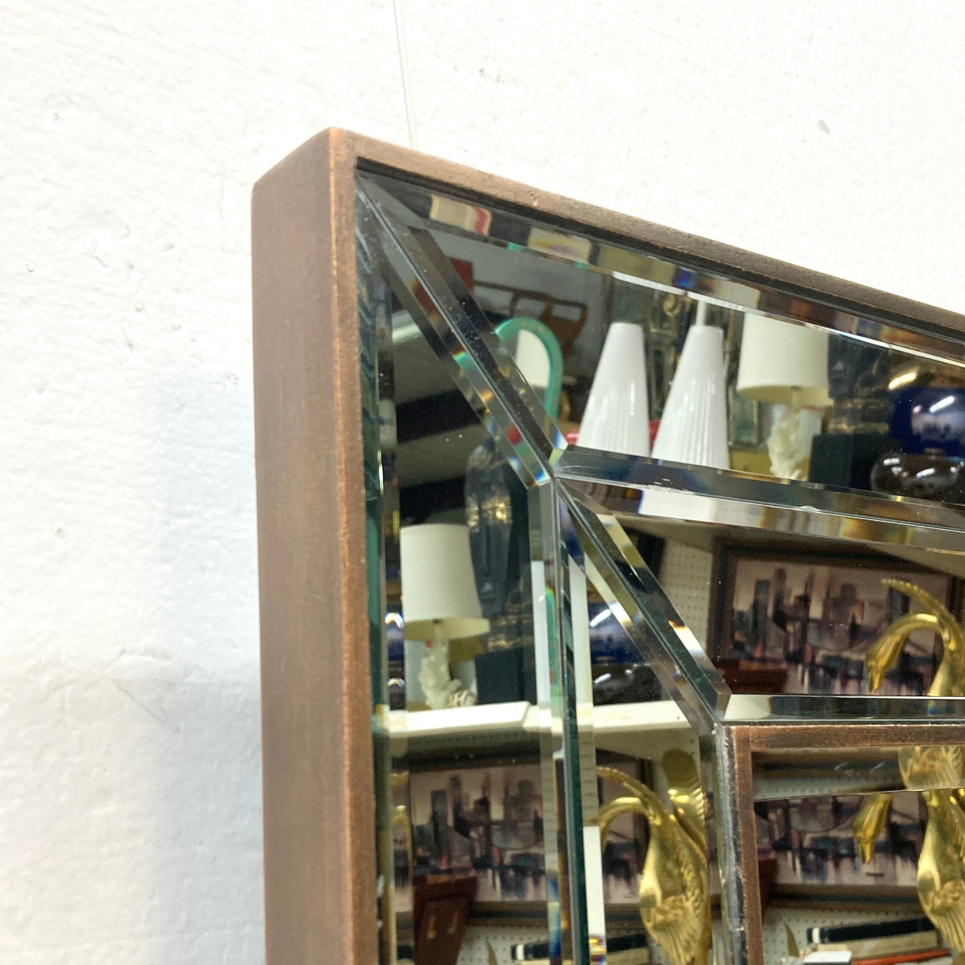 Geometric mirror with a copper-toned frame.