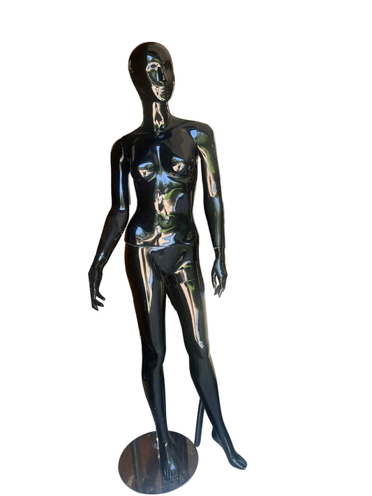 Black mannequin on a glass table with a blurred background
