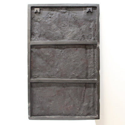 BAck of resin and glass artwork of large green leaves