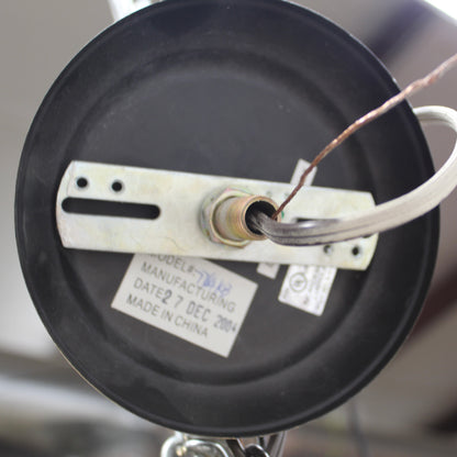 Close-up of a mechanical component with wires and labels on a blurred background