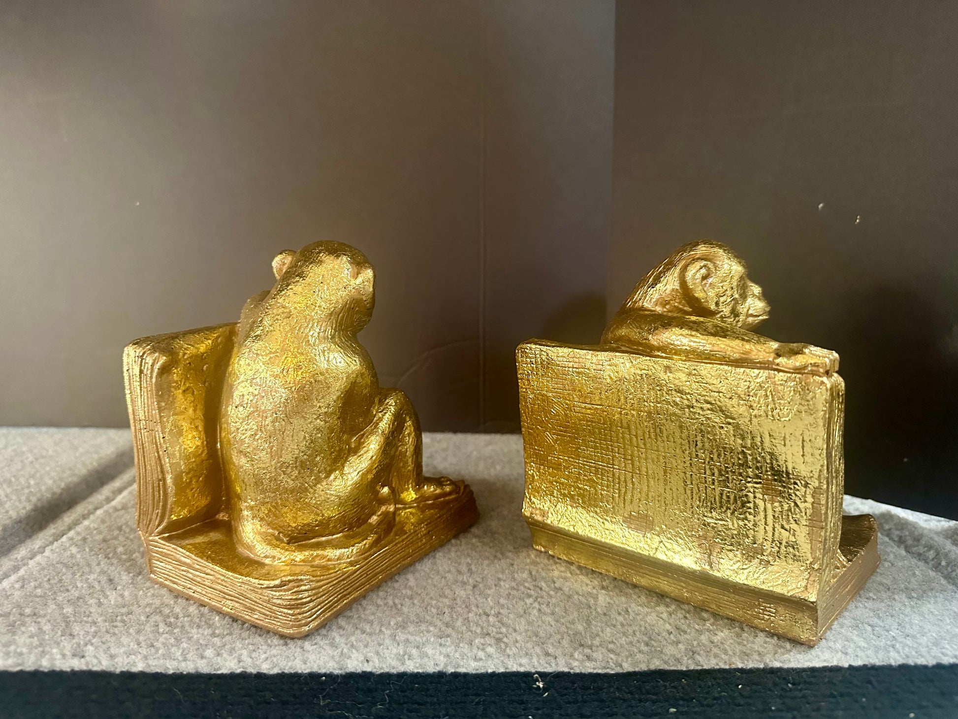 Gold monkey bookends on a neutral background