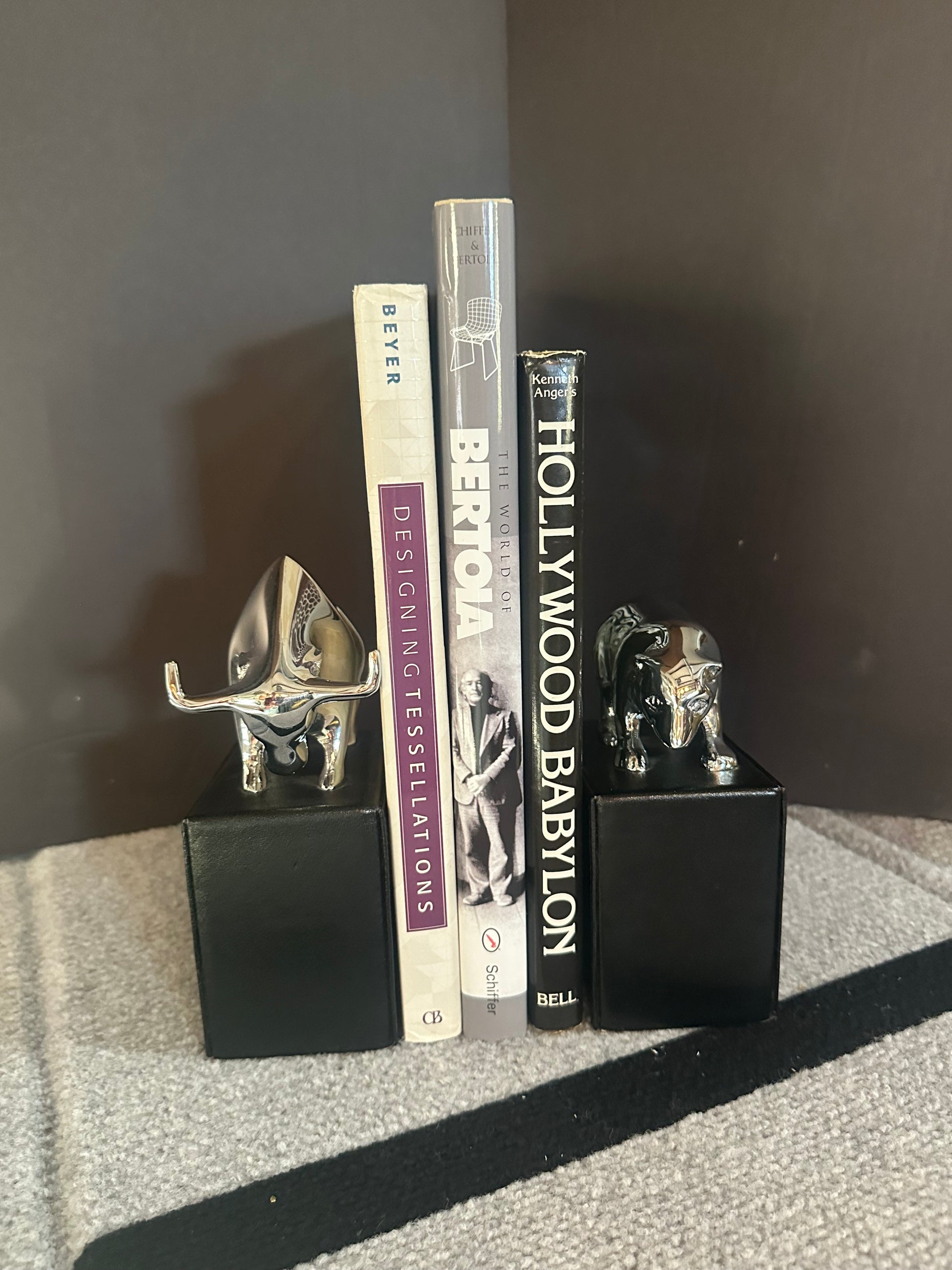 Stack of books with decorative items on a reflective surface