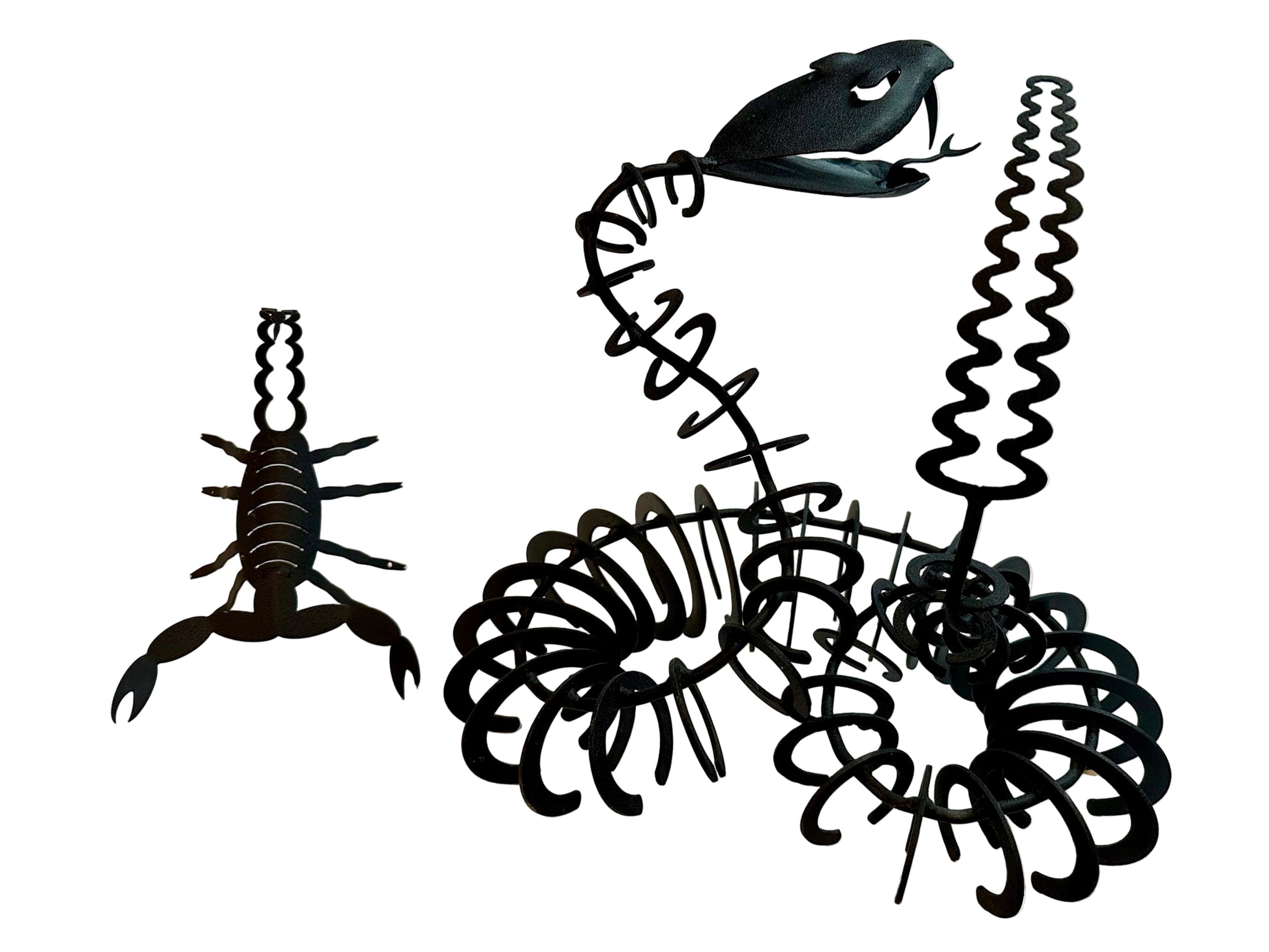 Black iron sculptures of scorpion and snake on a white surface