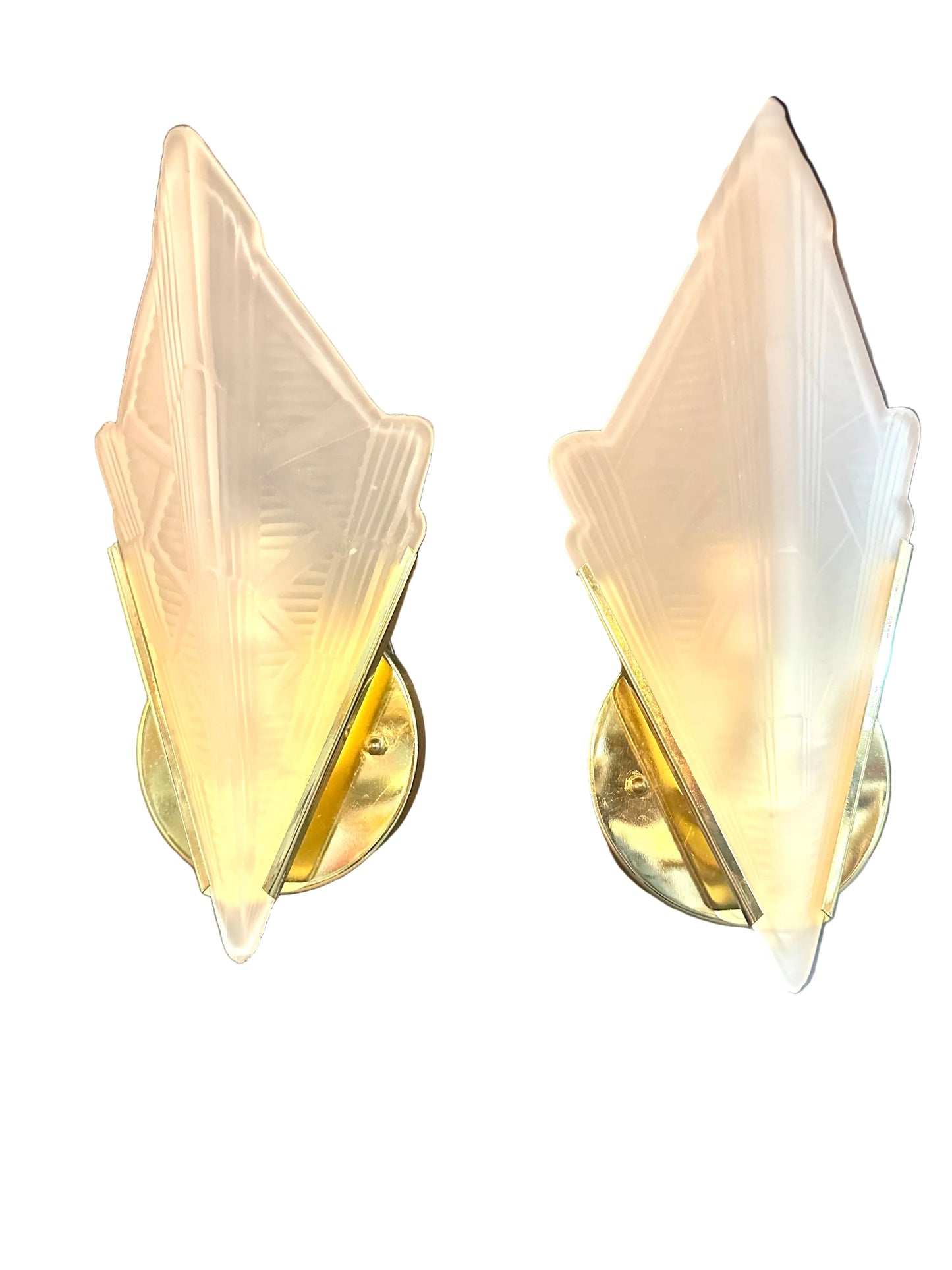 Pair of wall sconces with decorative glass shades on a neutral background