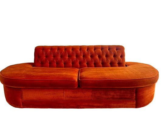 Orange tufted sofa in a living room 