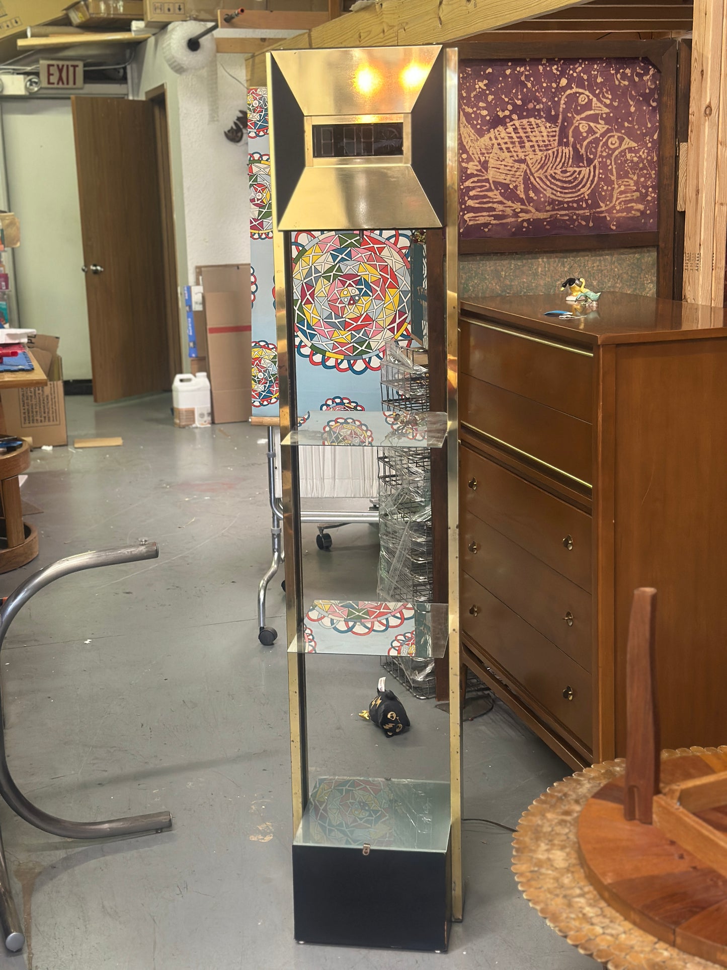 Tall glass display case in a room with furniture and decor