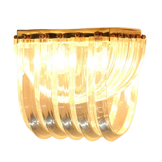 Chandelier with clear glass rings and gold accents on a beige background