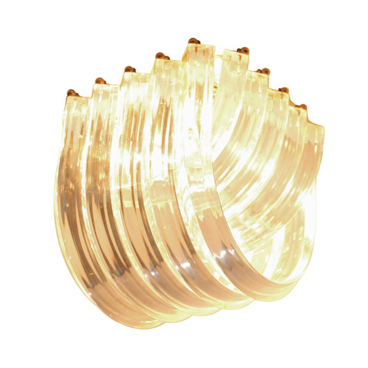 Modern chandelier with curved glass panels on a ceiling