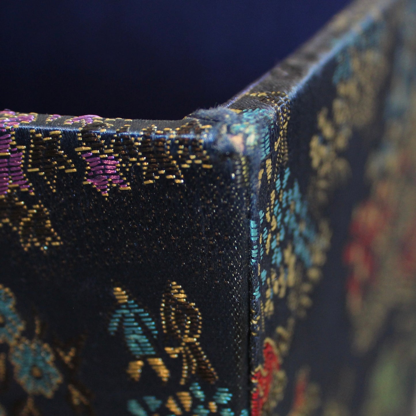 Corner of Navy blue Chinoiserie brocade square planter. 