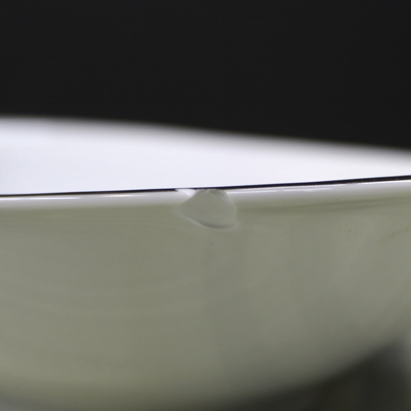 View of a chip in aVintage Mid-Century Meito Japan "Tempo" Oval Vegetable Serving Bowl - Atomic Swirl.