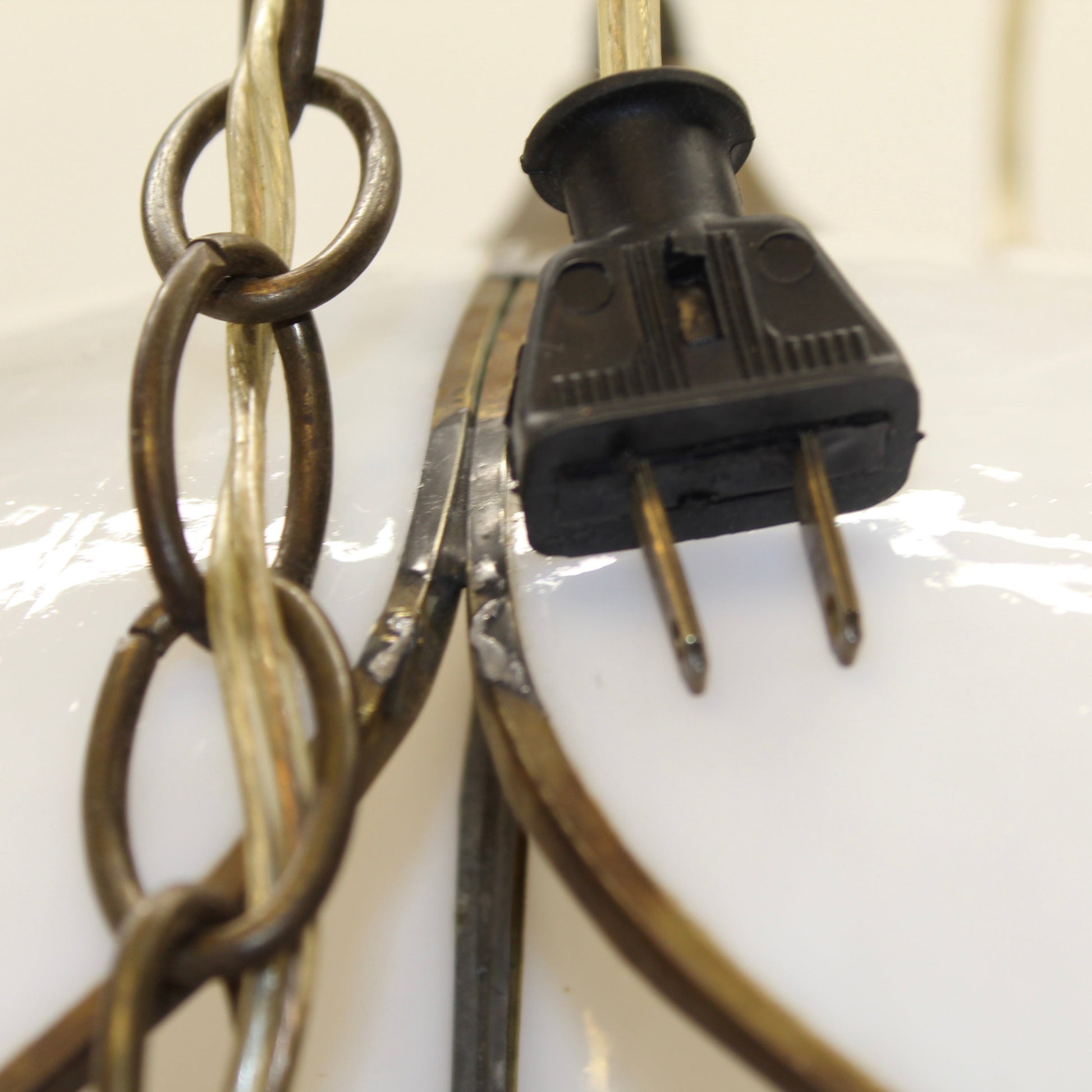 The plug of a double-layer tulip or lotus flower motif. The dual tiers of sculpted, milk-white slag glass petals are framed by dark, antiqued metal lead lines. 
