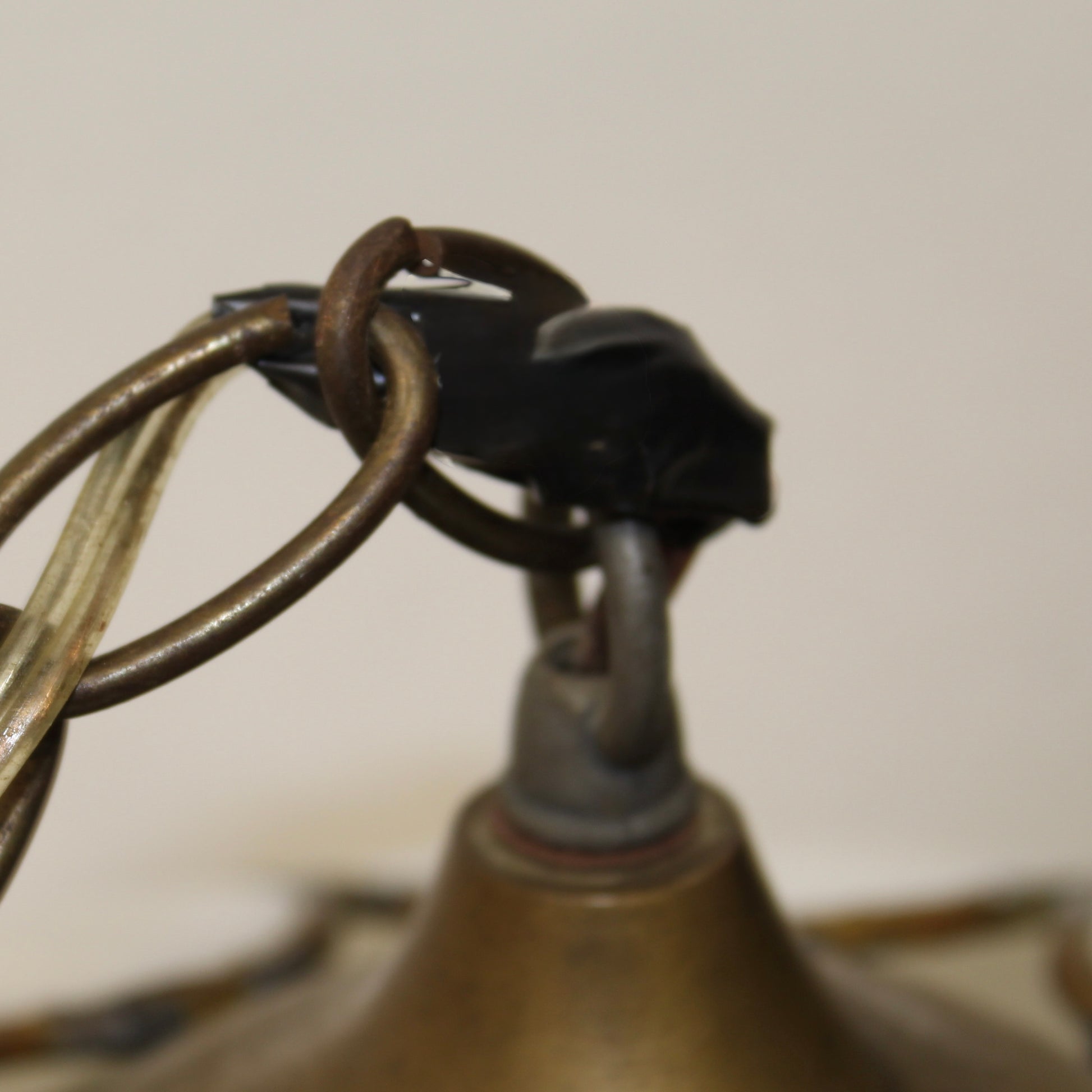 Wiring of a double-layer tulip or lotus flower motif. The dual tiers of sculpted, milk-white slag glass petals are framed by dark, antiqued metal lead lines. 